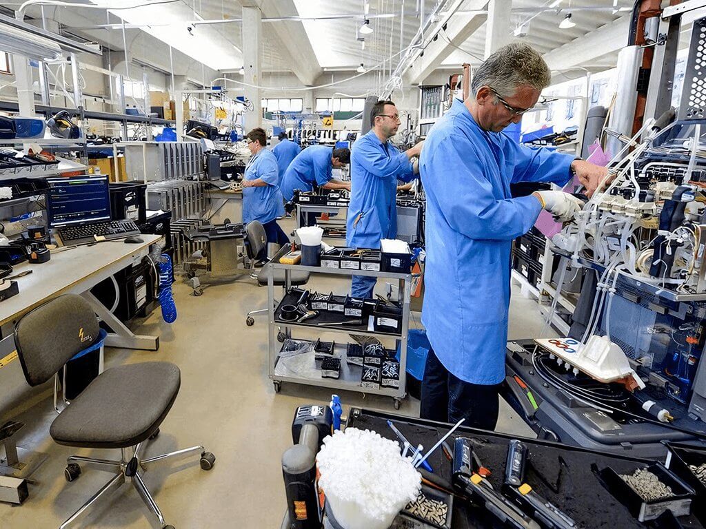 A worker is assembling medical equipment