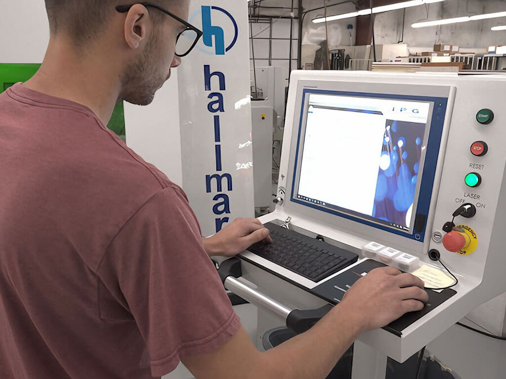A worker is operating equipment to test the medical PCBA boards being produced
